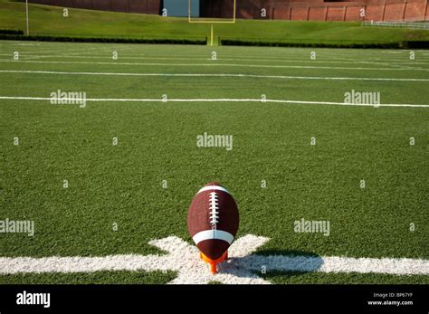 American Football On Kicking Tee On Field Showing Kickoff Stock Photo
