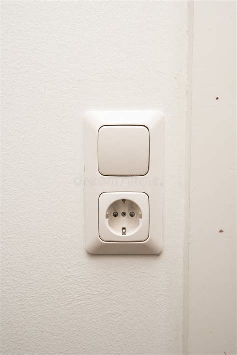 An Electrical Outlet And Light Switch On A Wall Stock Photo Image Of