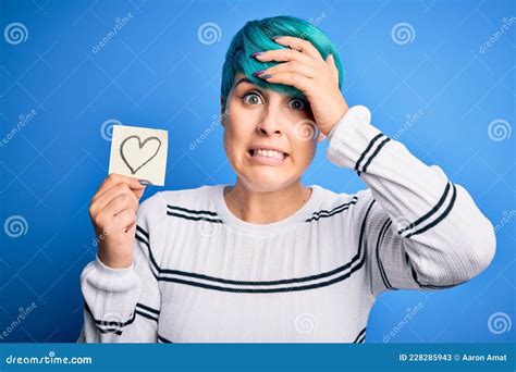 Young Woman With Blue Fashion Hair Holding Romantic Heart Shape On Note