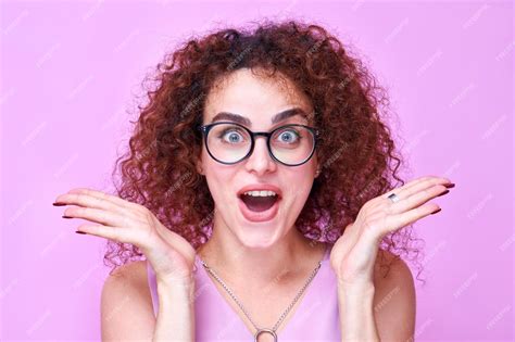 Premium Photo Armenian Shocked Positive Girl Raises Palms From Joy With Glasses And Open Mouth