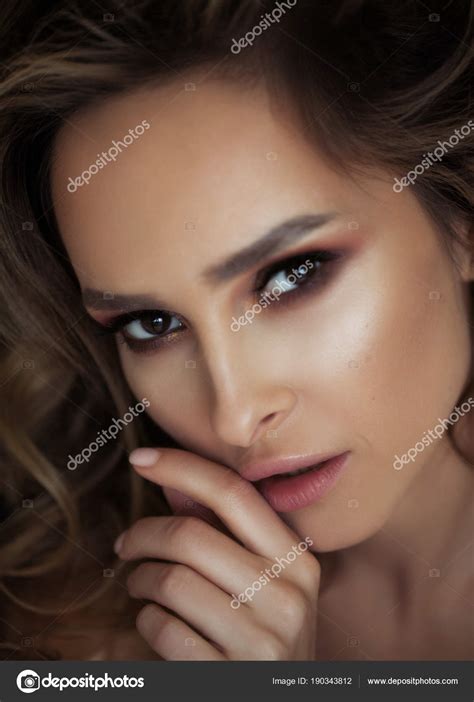 Portrait Of A Beautiful Young Woman With Perfect Make Up And Wavy Hair