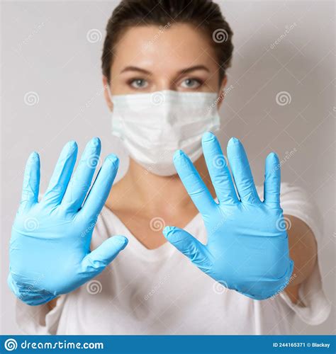 Woman Is Wearing A Face Mask And Latex Gloves For Protection Against