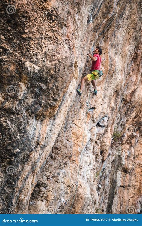 Climber Overcomes A Difficult Climbing Route On A Natural Terrain Stock