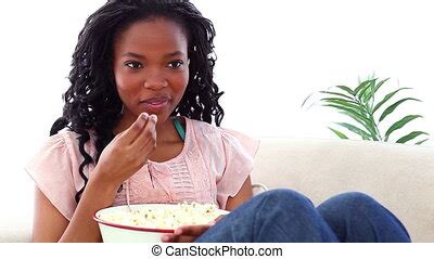 Excited Woman Eating Popcorn Watching Tv Side View Of An Excited Woman