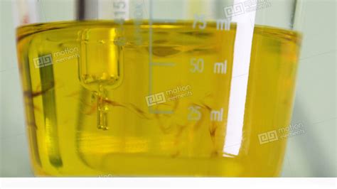 Yellow Liquid With Dark Impurities Mixed By Tool Macro Stock Video