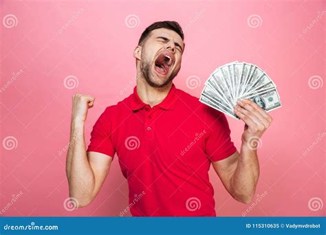 Portrait Of A Satisfied Young Man Holding Money Banknotes Stock Image