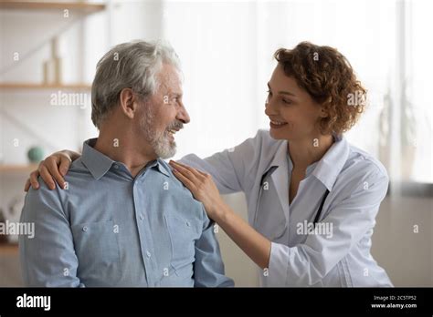 Caring Woman Doctor Comfort Elderly Male Patient Stock Photo Alamy