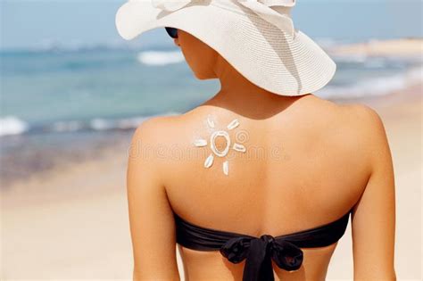 Woman Applying Sun Cream Creme On Tanned Shoulder In Form Of The Sun Sun Protection Skin Care