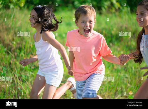 Group Of Happy Children Playing On Meadow Stock Photo Alamy