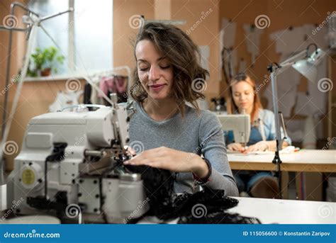 Women Dressmakers Work In The Workshop On Sewing Machines Stock Photo