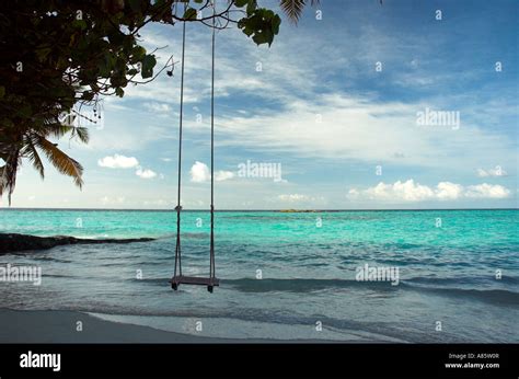 A Beach Swing Over The Shallow Water Of The Sea In The Maldives Stock