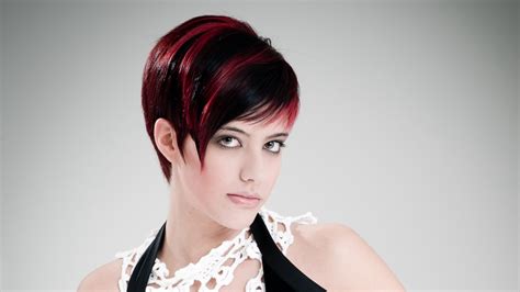 If you have a slightly red complexion, like this model, cool shades can help to tone down your rosy complexion. Sleek short haircut with a round back and fuchsia streaks