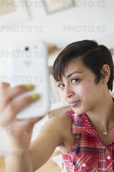 Mixed Race Woman Taking Selfie With Cell Phone Photo12 Tetra Images Jgi Jamie Grill