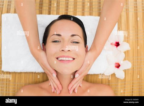 Smiling Brunette Enjoying A Facial Massage Stock Photo Alamy