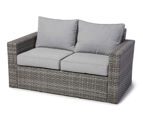 An Outdoor Sofa With Two Pillows On It