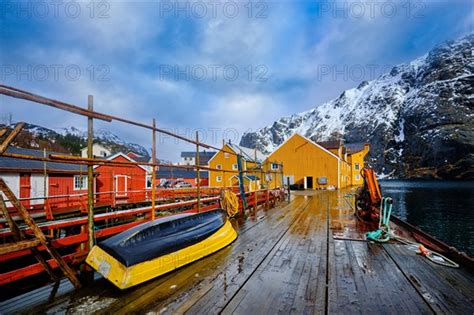 Nusfjord Authentic Fishing Village In Winter With Red And Yellow Rorbu