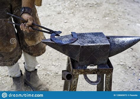 Maniscalco Forge A Horseshoe With The Hammer On The Anvil Stock Photo