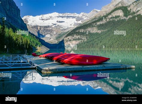 Red Canoes On Dock Lake Louise Banff National Park Alberta Stock