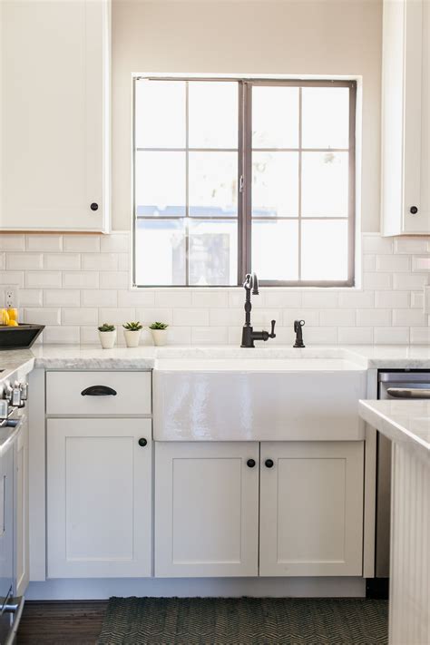 Farmhouse style kitchen cabinets with shaker style cabinet doors are typically made up of quality hardwood such as maple, quartersawn oak or hickory which are usually left in their raw, natural finish. White shaker style cabinetry with 30" farmhouse sink - by ...