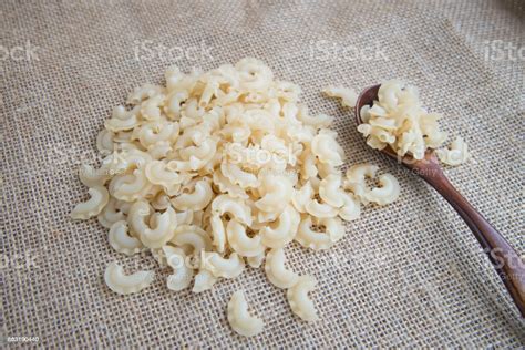 Short Curved And Ruffled Raw Pasta On Rustic Background Natural And