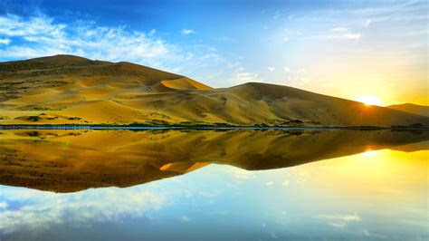 Desert Reflection On River During Sunrise Under Blue Sky