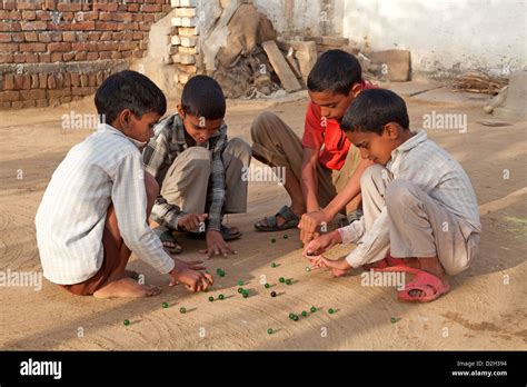 Group Of Children Playing Marbles Hi Res Stock Photography And Images