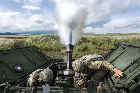 Mortar Blast. Soldiers use a 120 mm mortar system on an M1129 mortar carrier during a live-fire ...