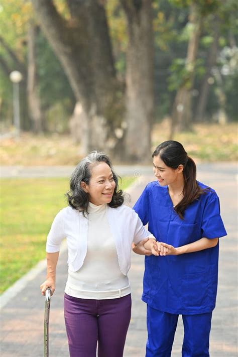 Image Of Caring Female Caregiver Talking Supporting Helping Elderly