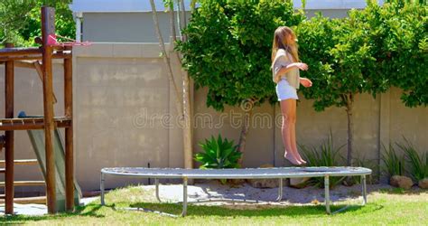 Girl Jumping On A Trampoline In The Garden 4k Stock Footage Video Of