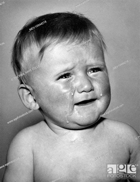 Studio Portrait Of A Little Boy Crying With Tears Running Down His