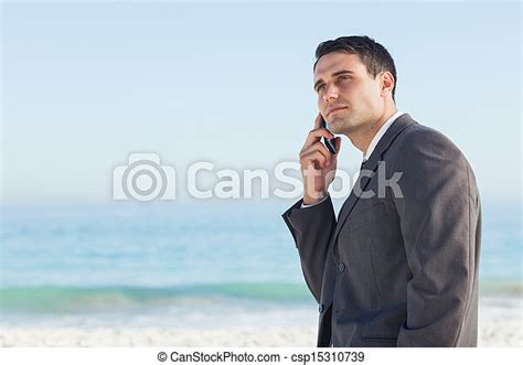 Pensive Businessman On The Phone At The Beach Canstock