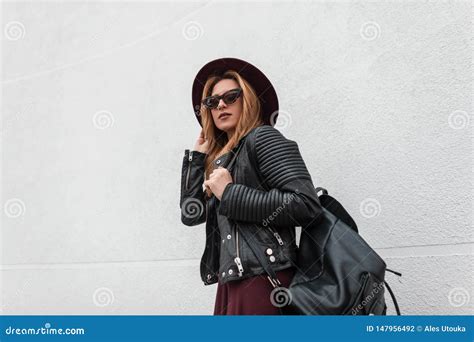 Urban Hipster Young Woman In A Fashionable Hat In Stylish Sunglasses In