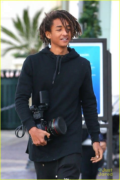 jaden smith looks like a regular photographer with his large camera mens braids hairstyles