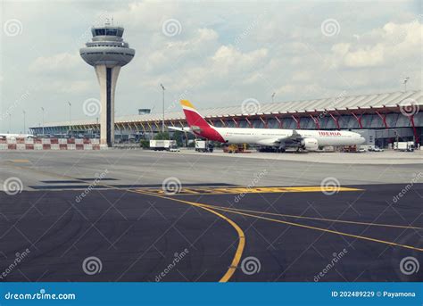 2018 9 May Madrid Spain Plane And Control Tower And Luggage Trucks