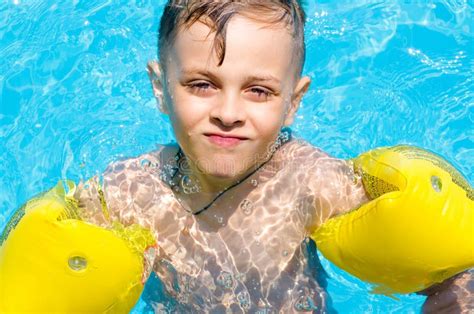 Little Boy Swimming In The Water With Armbands Stock Image Image Of