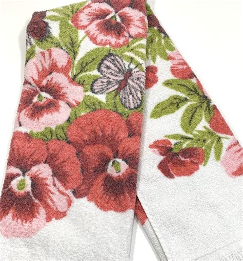 Two White Towels With Red And Green Flowers On Them