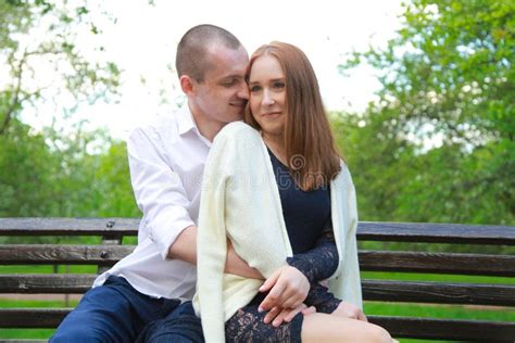 Romantic Couple On A Bench Hugs And Enjoys Together In Love Stock Image