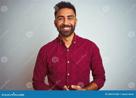 Young Indian Man Wearing Red Elegant Shirt Standing Over Isolated Grey