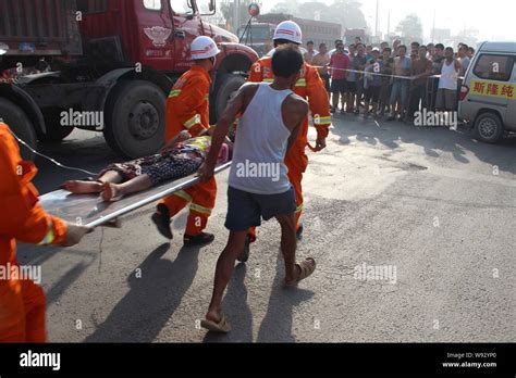 Rescuers Carry The 11 Year Old Girl Crushed By A Truck To An Ambulance