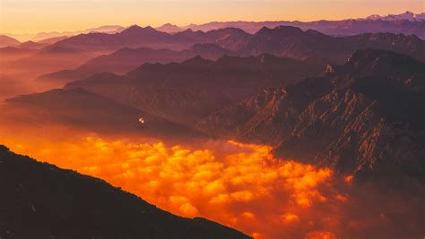 Scenic View Of Mountains Against Dramatic Sky At Sunset · Free Stock Photo