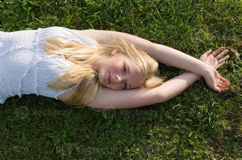 Teenage Girl Laying In Grass Stock Photo At Vecteezy