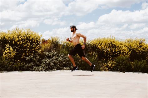 Free Photo Shirtless Male Athlete Running Near Field