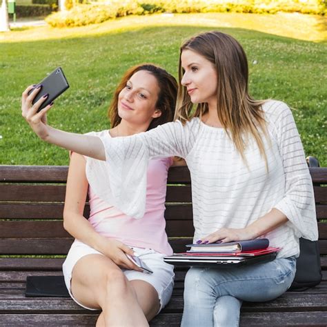 Free Photo Girls Taking Selfie On Bench