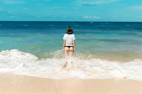 Beautiful Young Woman In Bikini Posing On The Beach Of A Tropical