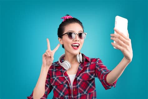 premium photo smiling lovely active asian girl taking selfie photo