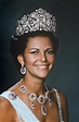 a woman wearing a tiara and smiling at the camera