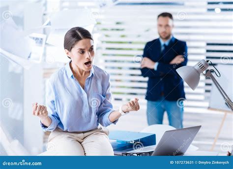 Angry Woman Clenching Her Fists And Shouting While Being Furious Stock