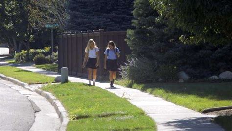 Two Teenage Girls Talking And Walking In School Uniforms Stock Video