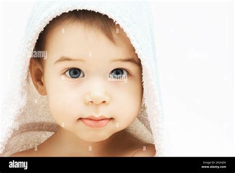 Cute Infant Boy With Beautiful Eyes Wrapped Into Hooded Towel After A