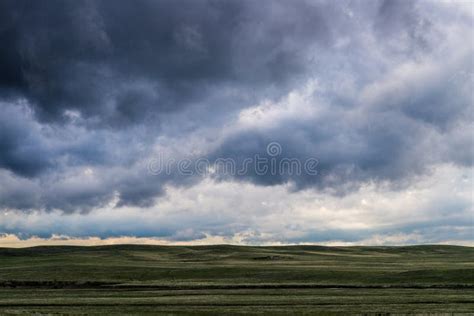 Storm Clouds Above Field Of Green Grass Stock Photo Image Of Colorado